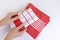 Woman holding new red checkered kitchen towels. Cooking, cleaning, laundry concept.