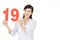 Woman holding number nineteen