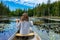 Woman holding oars paddling sitting in canoe