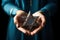 A woman holding an old and rusty star of David in their hands.