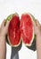 Woman holding parts of cracked watermelon.Two parts of ripe juicy watermelon