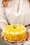 Woman holding peach cheese cake