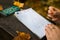 Woman holding a pen and filling in the visitor`s book in park