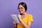 Woman holding pen writing in notebook at studio