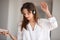 Woman holding phone dancing listening to music playing in headph