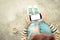 Woman holding phone white screen on top view vintage style