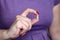 Woman holding a pill, medication in capsule