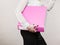 Woman holding pink binder with documents