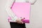 Woman holding pink binder with documents