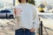 Woman holding pink takeaway cardboard cup on city street, closeup. Coffee to go