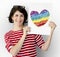 Woman holding placard with LGBT heart icon