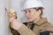 Woman holding plaster spatula peeling ceiling