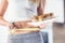 Woman holding plate with cakes and measure tape.