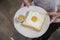 Woman holding a plate of Fried Egg Toast.