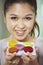 Woman holding a plate of macaroons. Conceptual image