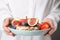 Woman holding plate with tasty crispbreads, fruits and sweet berries, closeup