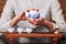 Woman holding porcelain teapot in front of the camera.