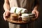 Woman holding products for spa procedures on dark background, closeup