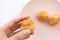 Woman holding profiterole, close-up. Cream puff cakes dessert in dish. French pastry