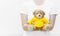 Woman holding and protecting give a brown Teddy Bear toy wear yellow shirts sitting on white background close-up
