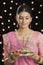 Woman holding a puja thali on Diwali