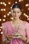 Woman holding a puja thali on Diwali