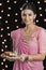 Woman holding a puja thali on Diwali