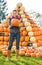 Woman holding pumpkin in front of pumpkin piramide