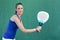 Woman holding racket paddleball and waiting ball. sportswoman.