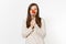 Woman holding red fresh tomato on fork in front nose like clown isolated on white background. Proper nutrition