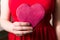 Woman holding red love heart in hand, Valentines day gift closeup