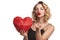 Woman holding red polygonal paper heart shape blowing a kiss at camera