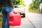 Woman holding a Reserve oil  tank To refuel the pickup truck Parked on the roadside