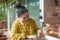 Woman holding resin pine cone for check over