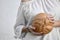 Woman holding a round loaf of crusty bread