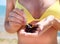 Woman holding a sea urchin for eating it on the beach