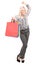 Woman holding shopping bags and gesturing success
