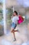 Woman holding shopping bags and walking smile happy on the day