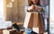 A woman holding and showing shopping bags with tablet pc and postal parcel box on the table for online shopping