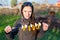 Woman holding skewers of fresh vegetables