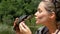 Woman is Holding a Small River Turtle in her Hands near Face on Nature. Slow Motion