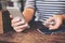 A woman holding smart phone while playing fidget spinner