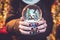 Woman holding snow globe on the Christmas fair