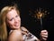 Woman holding sparkler and celebrating