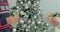 Woman holding sparkling champagne celebrating Christmas with her husband with xmas tree in the background.