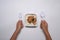 Woman holding spoon and fork ready to microwave and eat frozen fried pork with garlic.