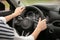 Woman holding steering wheel in car, closeup.