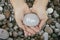 Woman holding stone with the word Hope in her palms