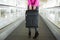 Woman holding suitcase in airport