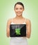 Woman holding tablet pc with green electrical plug